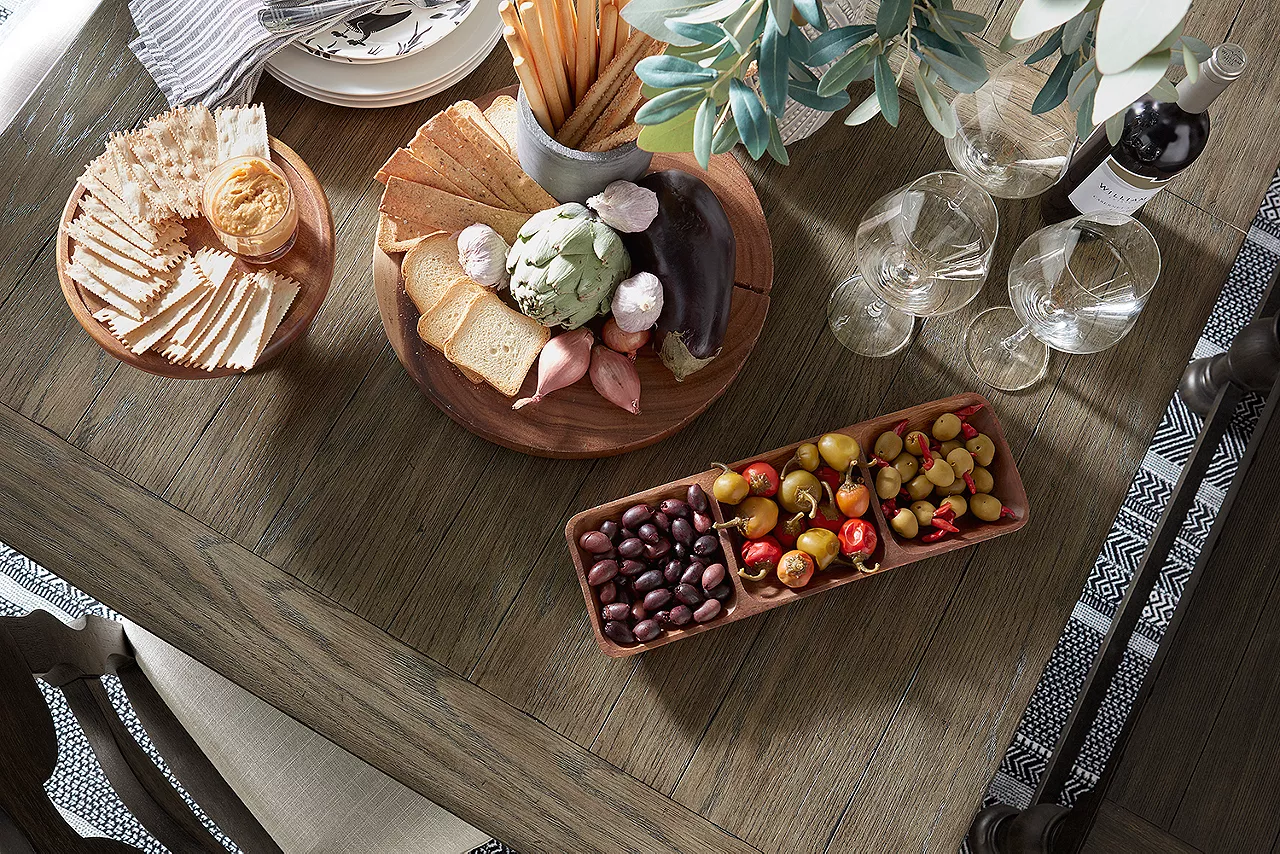 Closeup of the Barrington Dining Table in Antique Oak/Matte Black and a Dining Chair and Bench in Matte Black in a room scene.